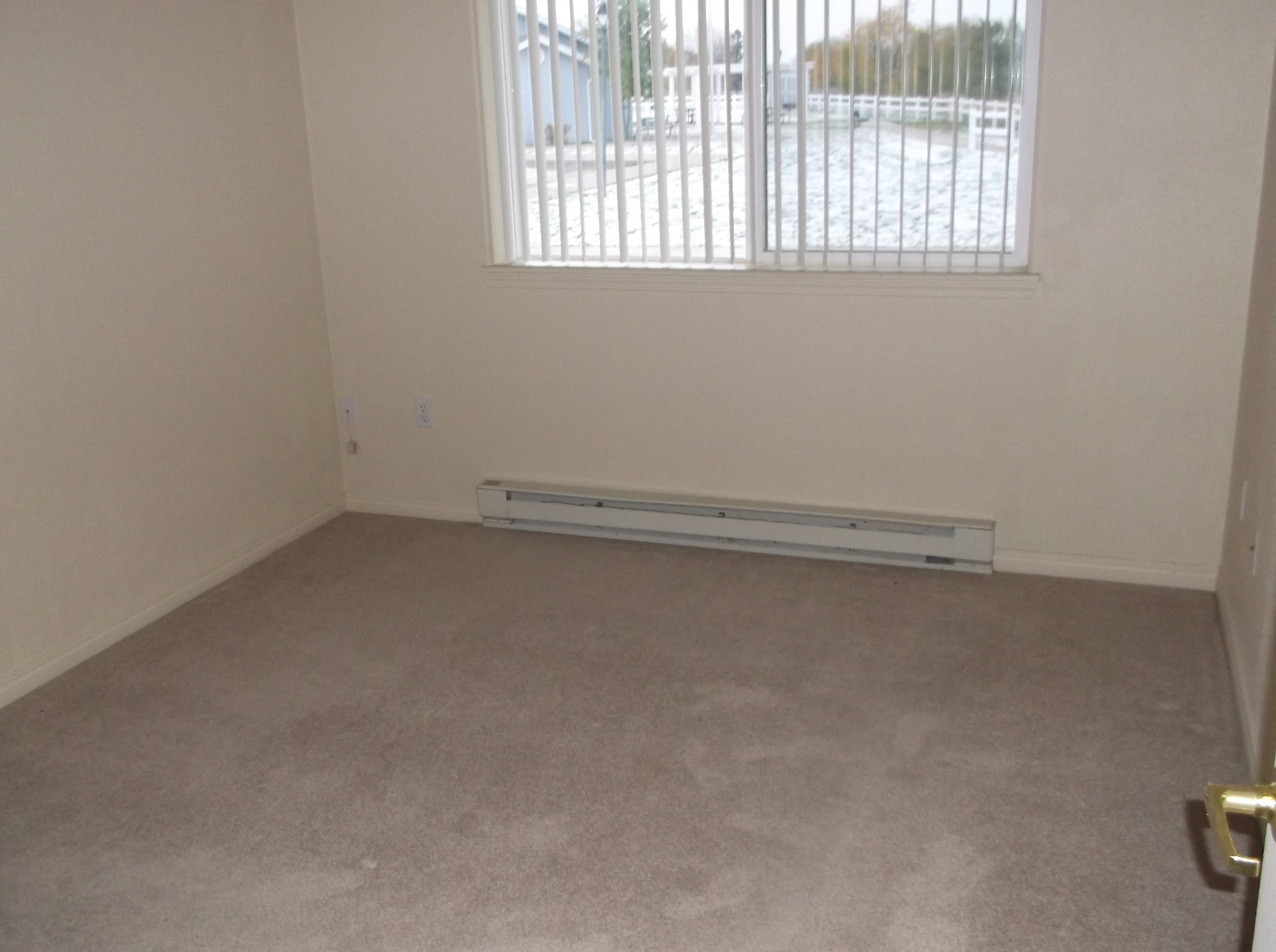 Image of room with window and baseboard heater